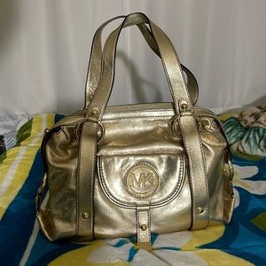 Beautiful gold Micheal Kors bag, and in excellent condition never worn.